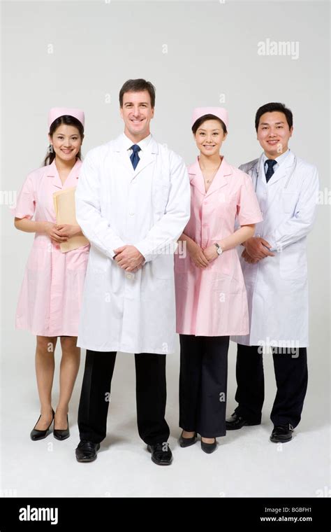 Doctors With Nurses In Pink Uniforms Stock Photo Alamy