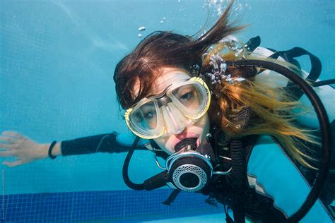 portrait of a beautiful woman scuba diving underwater in the swimming pool stocksy united