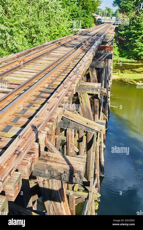 Side View On Top Of Railroad Bridge Of Old Wood Over Water Stock Photo