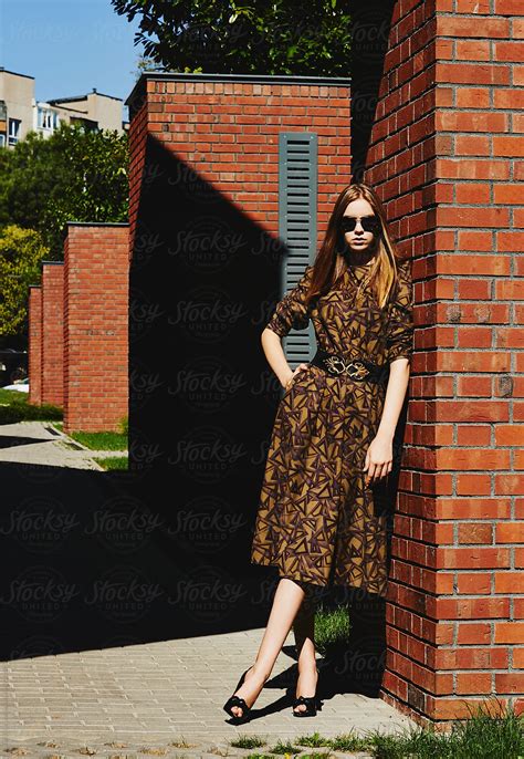 Blonde Girl Posing Against Brick Walls By Stocksy Contributor Atakan