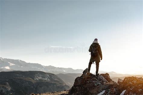 Girl Hiker Stands On Rock And Looks At Mountains And Sunset Stock Image