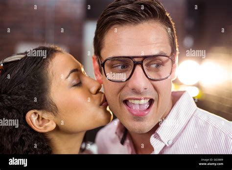 Woman Kissing Man On Cheek Stock Photo Alamy