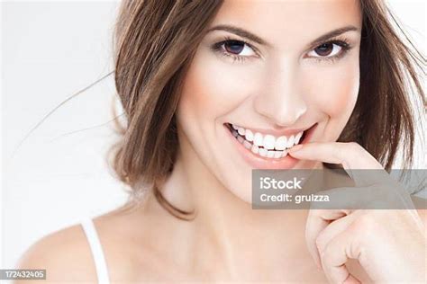 Cheerful Young Brunette Woman With Beautiful Smile Biting Finger Stock