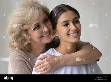 Close Up Happy Mature Mother Hugging Adult Daughter From Back Stock