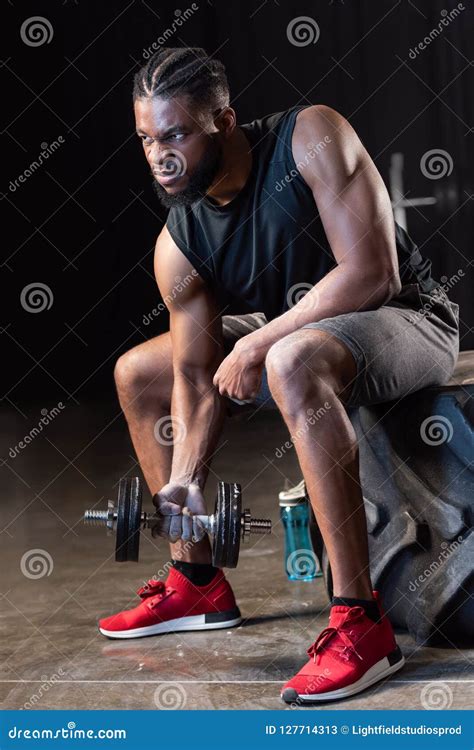 muscular african american sportsman sitting on tyre and exercising stock image image of