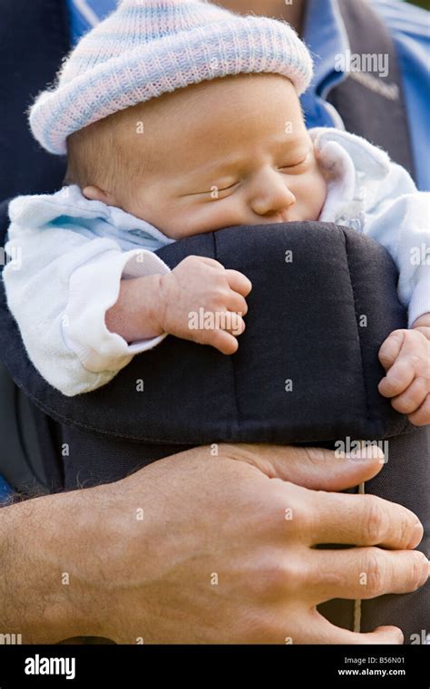 A Father Carrying His Baby In A Baby Carrier Stock Photo Alamy