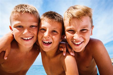 Three Happy Boys On The Beach Stock Photo Download Image Now 8 9