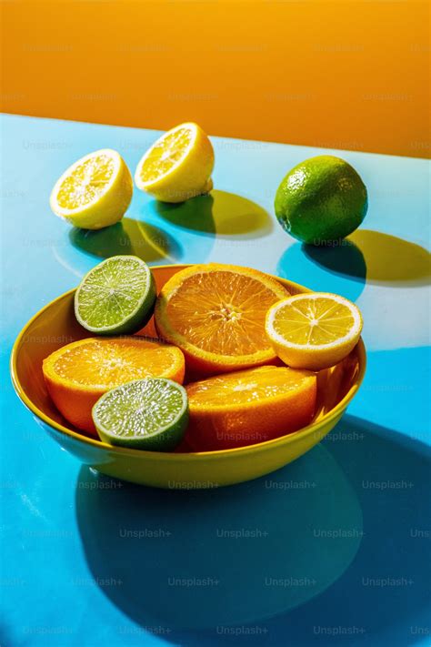 A Bowl Of Oranges And Limes On A Table Photo Limes Image On Unsplash