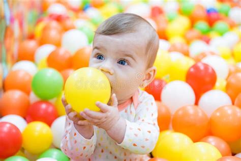 Baby Girl Playing With Colorful Balls Stock Photo Image Of Eyes