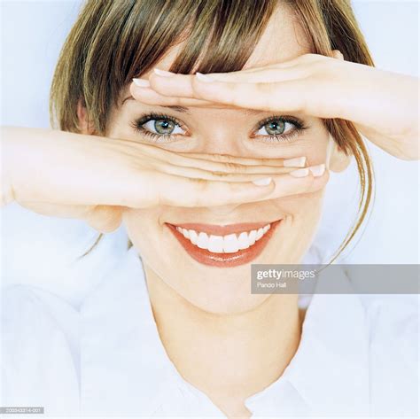 Young Woman Holding Hands Across Face Smiling Portrait Closeup High Res