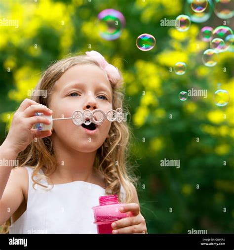 Cute Girl Blowing Bubbles Oudoors Stock Photo Alamy
