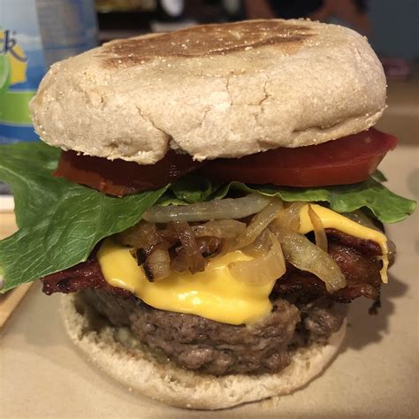Homemade Bacon Cheeseburger With Lettuce Onion And Tomato On An
