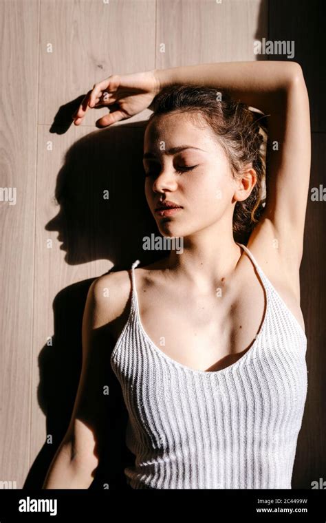 Directly Above View Of Beautiful Young Woman Lying With Eyes Closed On