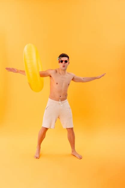Free Photo Full Length Image Of Playful Naked Man In Shorts And Sunglasses