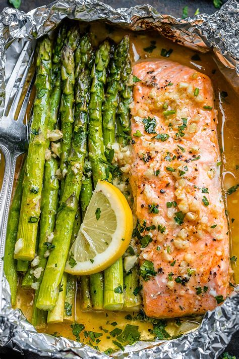 Baking salmon in foil traps the moisture i've discovered that baking salmon in foil is a wonderful way to cook salmon and i happen to think it turns out better than cooking it on the grill. Baked Salmon in Foil Packs with Asparagus and Garlic Butter Sauce - Best Salmon Recipe — Eatwell101