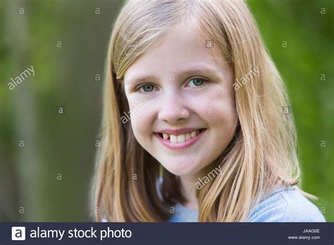 Portrait Of Smiling Pre Teen Girl Outdoors Stock Photo Alamy