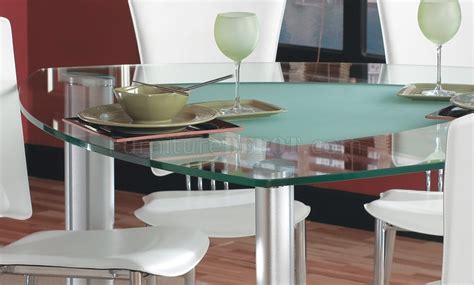 Bold faux marble top veining surrounds these triangle shaped coffee tables and faux marble top design printed glass adds a sophisticated, glossy feel, and beveled edges craft a realistic stone look. Triangle Glass Top Modern Dining Set 7Pc w/White Chairs