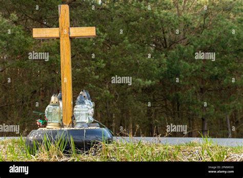 A Roadside Memorial Cross With A Candles Commemorating The Tragic Death