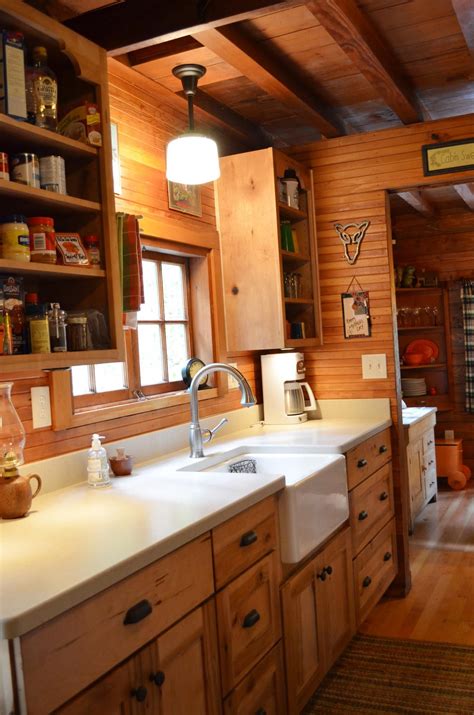 This striking rustic kitchen in a montana cabin features plenty of warmth with it's heavy use of wood, from the flooring to the wood ceiling beams. Rustic Cabin - Galley Kitchen (Cultivate.com) | log home ...