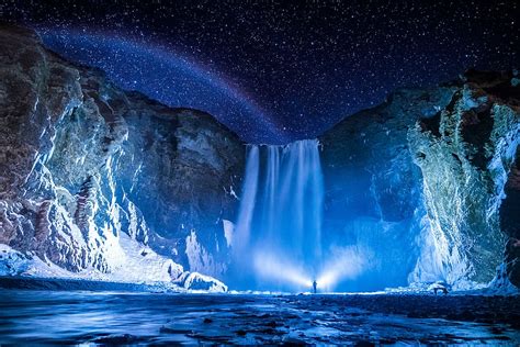 Person Front Waterfalls Nighttime Landscape Photograph Lighted