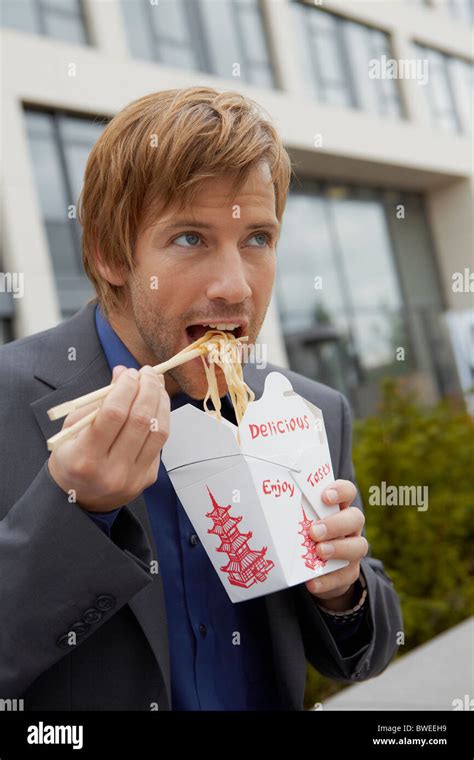 Man Eating Chinese Take Away For Lunch Stock Photo Alamy