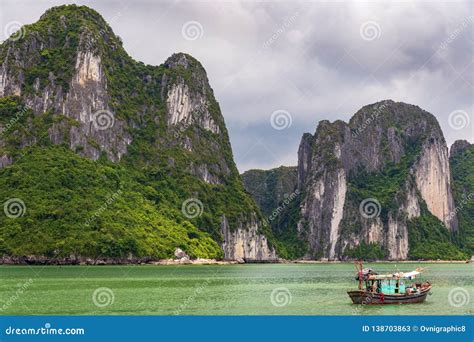Halong Bay Limestone Cliffs With Traditional Green Fishing Boat Unesco