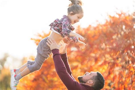 Dad With His Daughter In The Autumn Park Walks Stock Photo Image Of
