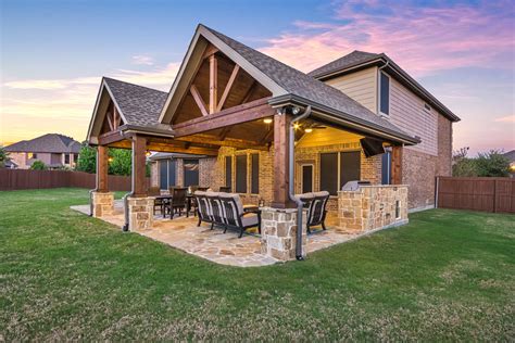 A custom pergola covered with a tinted polycarbonate roof is the perfect solution for those with a desire for natural light in an outdoor kitchen. Patio Cover and Kitchen in Murphy - Texas Custom Patios