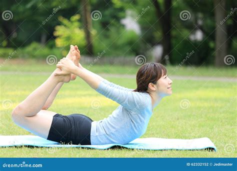 Japanese Woman Doing Yoga Bow Pose Stock Photo Image Of Relax Grass