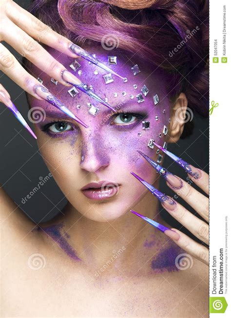 Girl With Bright Purple Creative Makeup With Crystals And