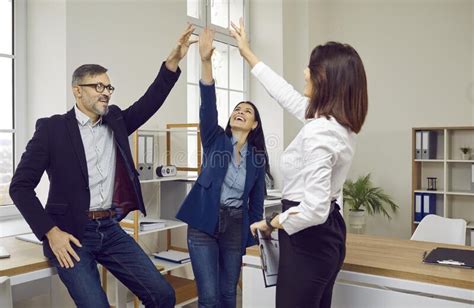 Happy Successful Business Team Giving High Five Celebrating Achievement
