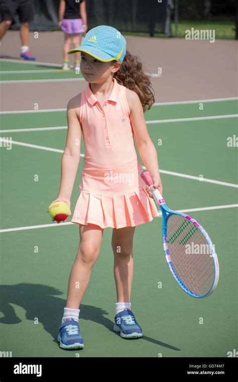 A Little Girl Playing Tennis On An Outdoor Court Stock Photo Alamy