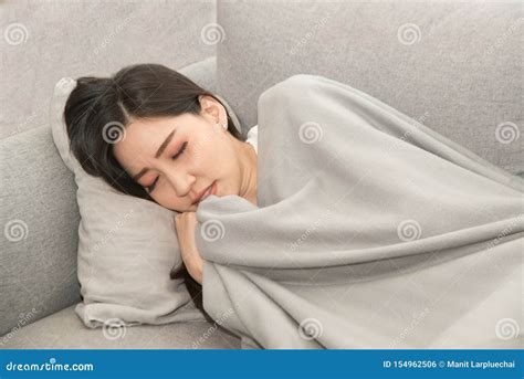 Asian Sick Woman Covered With A Blanket Lying In Bed With High Fever