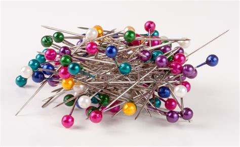 Pile Of Multi Colored Sewing Pins On A White Background Stock Image