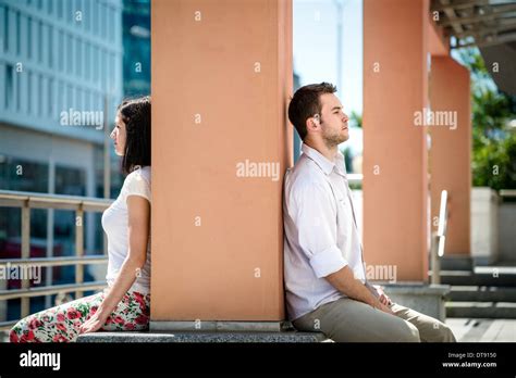 Couple Having Problems Two People Sitting On Opposite Side Of Big