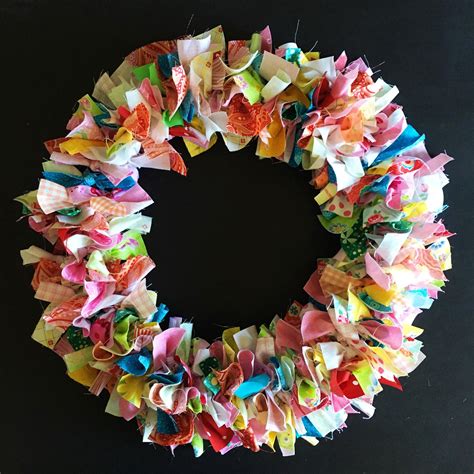 A Close Up Of A Wreath Made Out Of Different Types Of Paper Flowers On