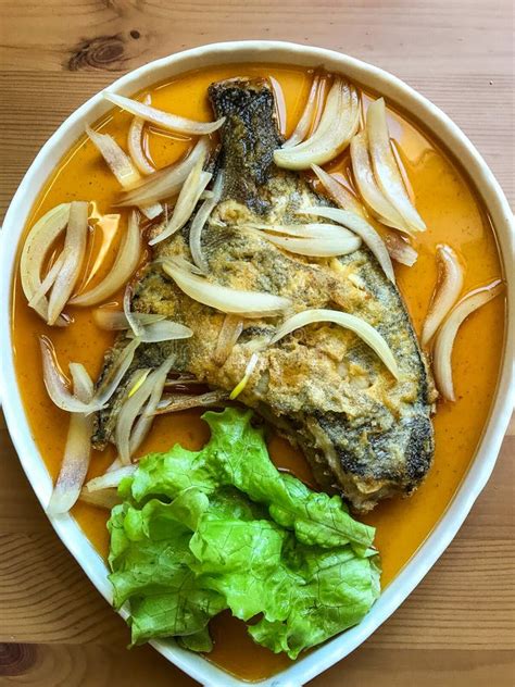 Deep Fried Flounder With Onions And Vegetables In Asian Sauce On A