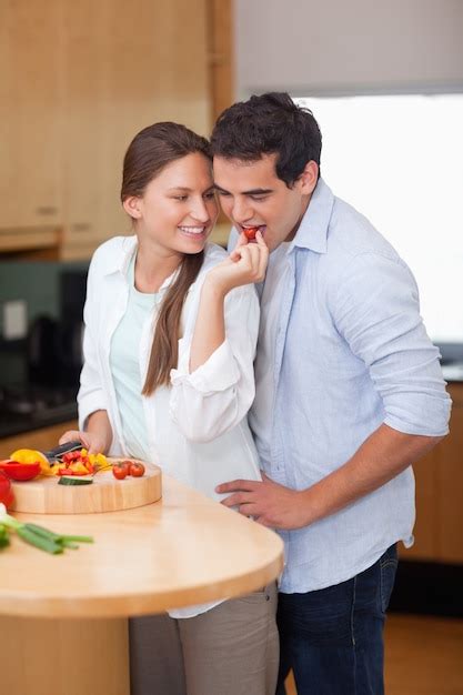 premium photo portrait of a woman feeding her husband