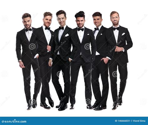Group Of Elegant Young Men In Tuxedos Standing Together Stockbild