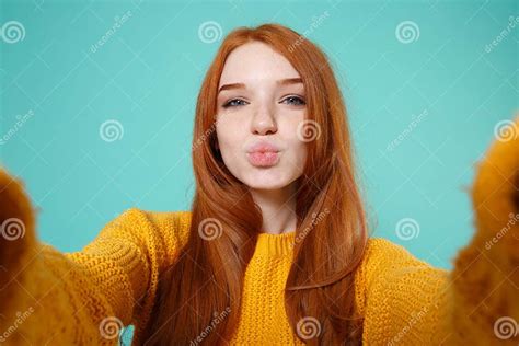 Close Up Of Cute Redhead Girl In Yellow Sweater Isolated On Blue Turquoise Background People