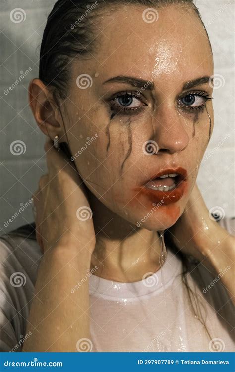 Portrait Of A Young Girl Looking At Camera With Dripping Makeup Standing In The Shower Vertical