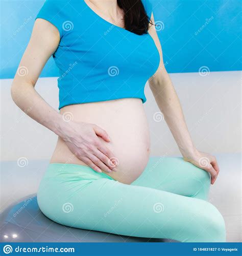 Pregnant Woman Sitting On Fit Ball Touching Her Belly Stock Image Image Of Home Touch 184831827