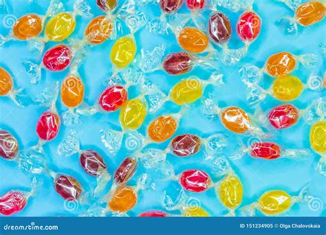 Pattern Of A Variety Of Multi Colored Candy On A Blue Background Stock