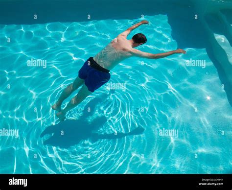 motionless body of swimmer drowned floating in swimming pool concept photo posed by model