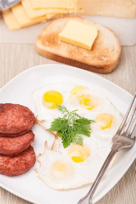 Breakfast With Fried Eggs Sausage And Toast On Plate Stock Image