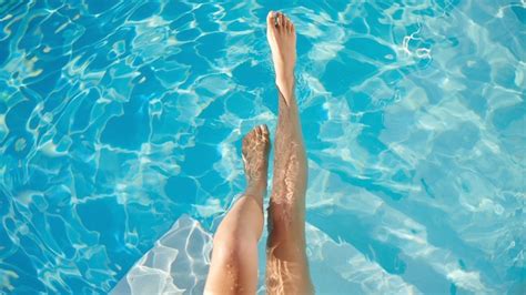 Premium Photo Easing Into Summer Feet First Cropped Shot Of A Womans Legs In The Water Of A