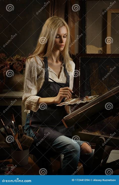 Beautiful Blonde Girl Artist Paints An Oil Painting In Artist S Studio