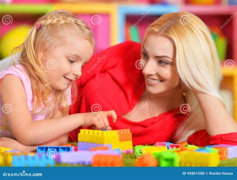 Happy Mother Playing With Her Daughter In The Designer Stock Photo