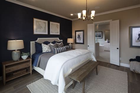 A Navy Blue Accent Wall In The Bedroom Creates A Look Of