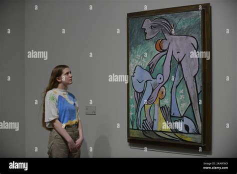 Employees pose during a press preview of ‘The EY Exhibition: Picasso